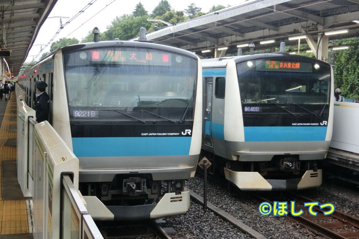 Two Keihin-Tohoku Line trains lined up on Yamanote Line track at Nishi-Nippori Station